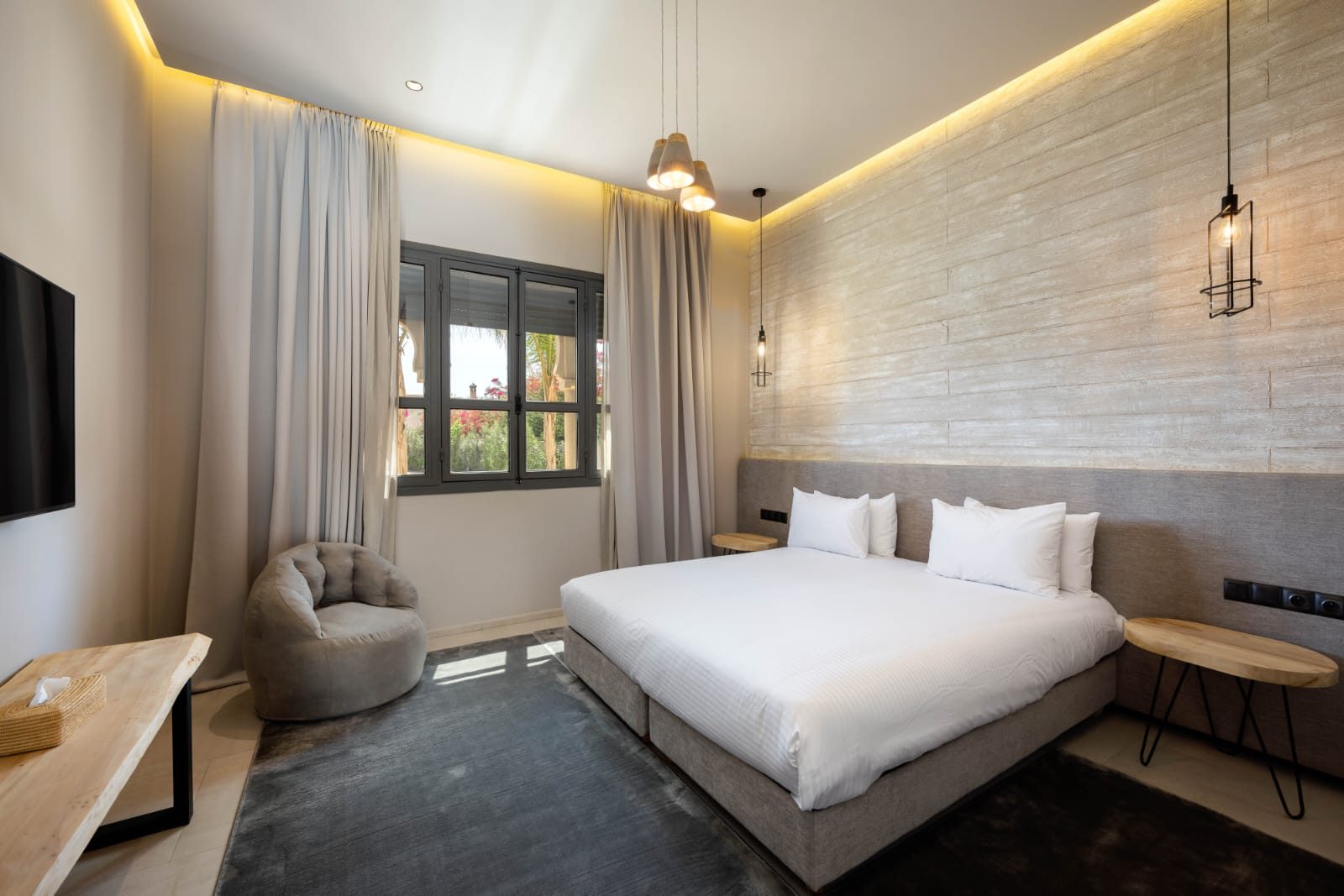Riad room with a double bed and a garden window